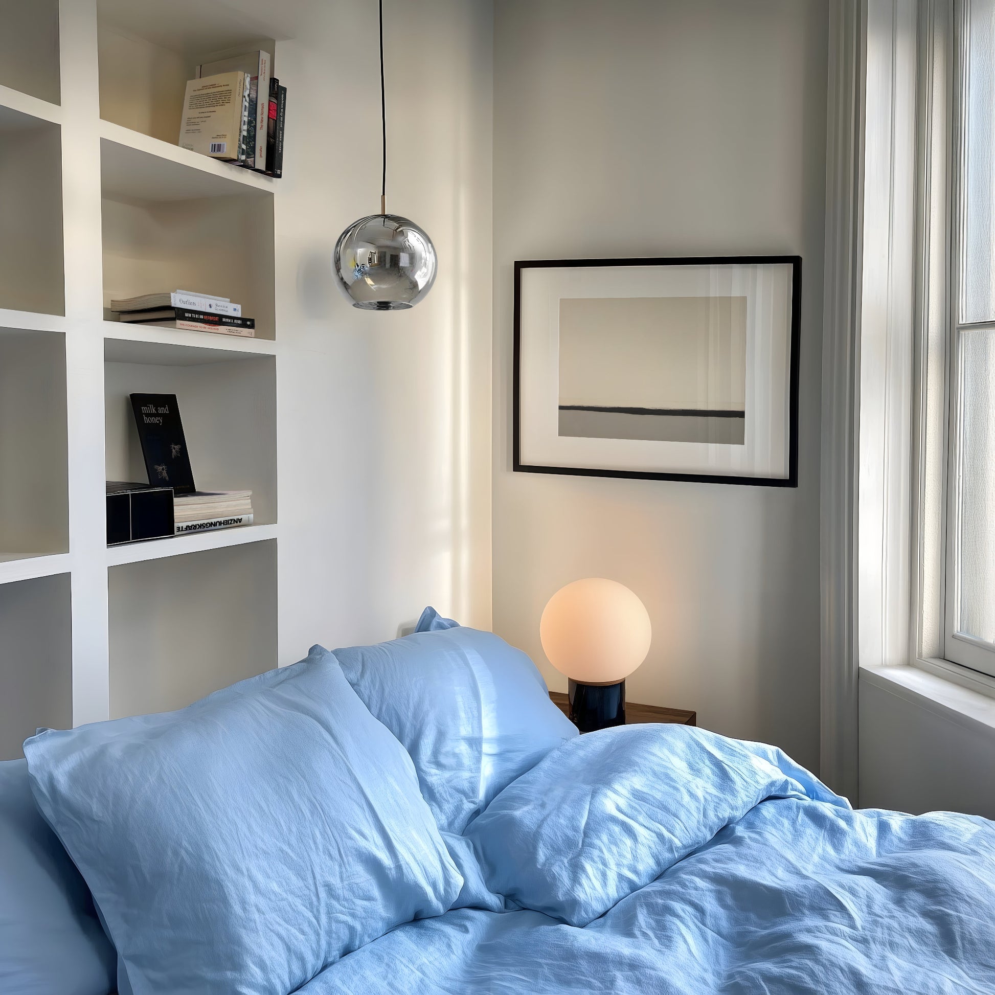 Neutral wall art in minimal bedroom